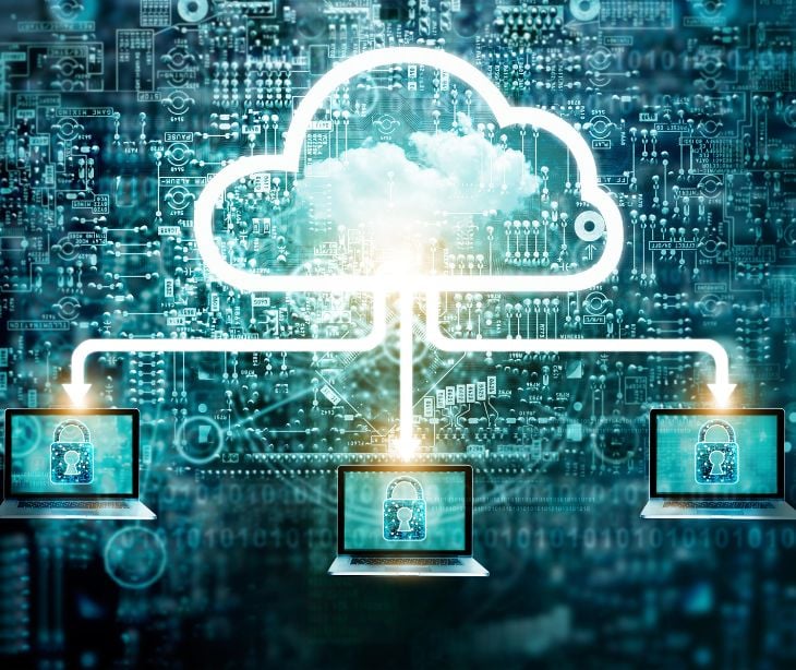 digital graphic of cloud connecting to three laptops