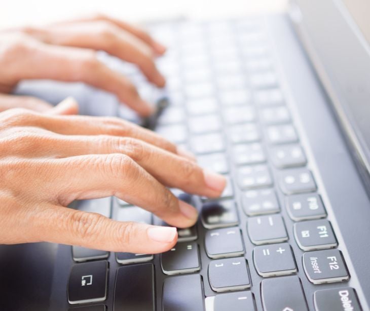 Someone typing on a computer. 