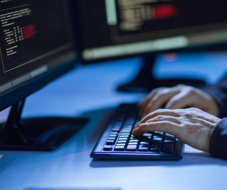 hands on keyboard with screens