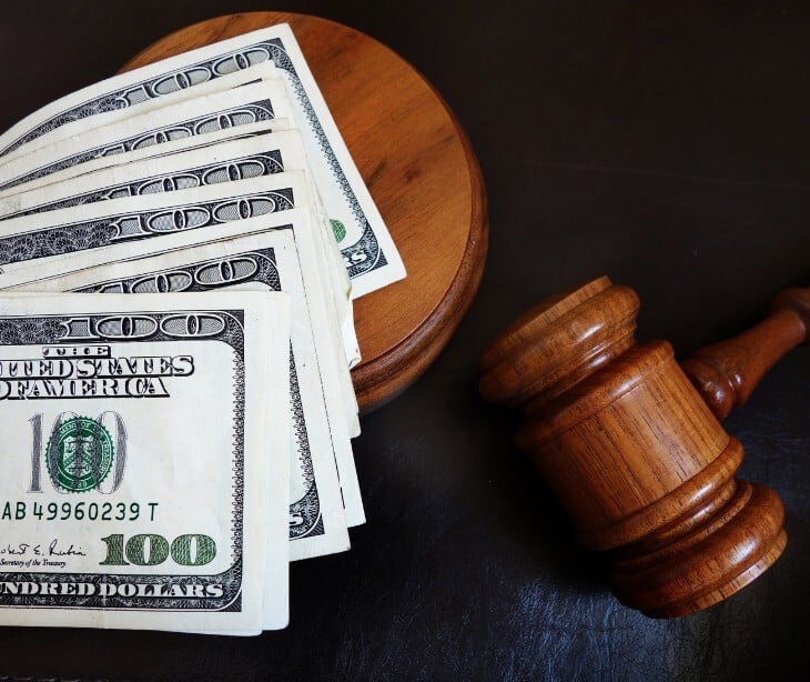 Image of a gavel and some money. 