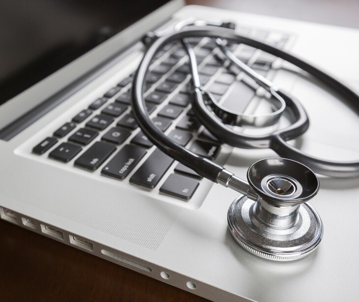 Image of a stethascope on a laptop. 
