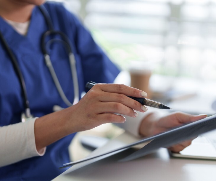 Image of a healthcare practicioner looking at a document. 
