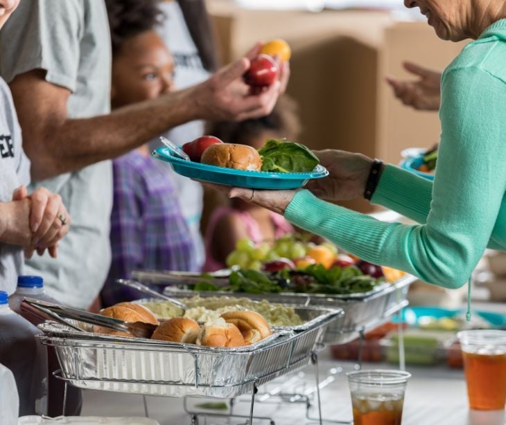 Image of volunteers giving out food. 