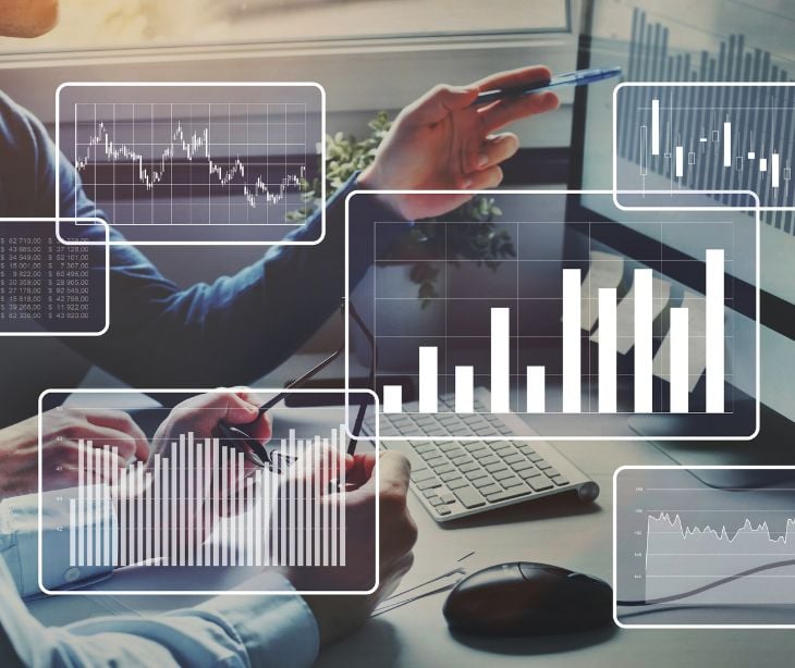 people using a computer with chart and graphs