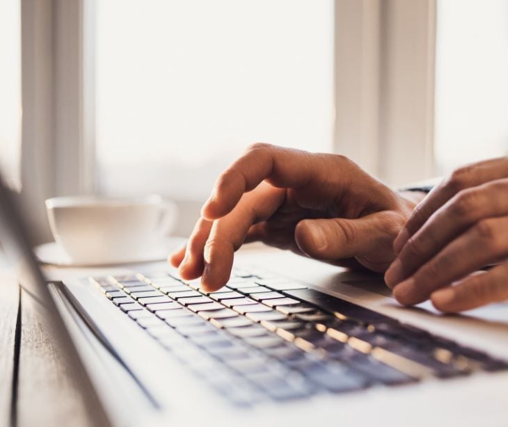 Image of someone typing on a computer. 