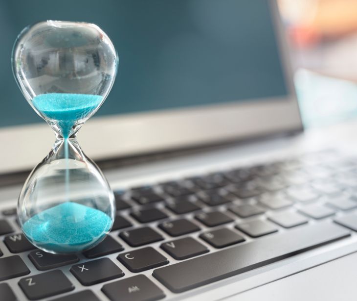 sand timer on a laptop keyboard