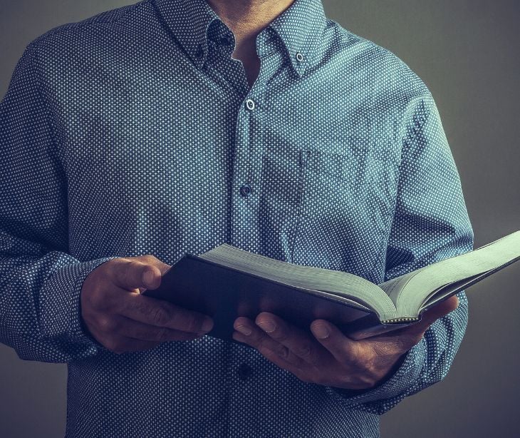Image of a pastor holding the bible. 