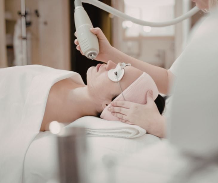 woman at spa with facial laser