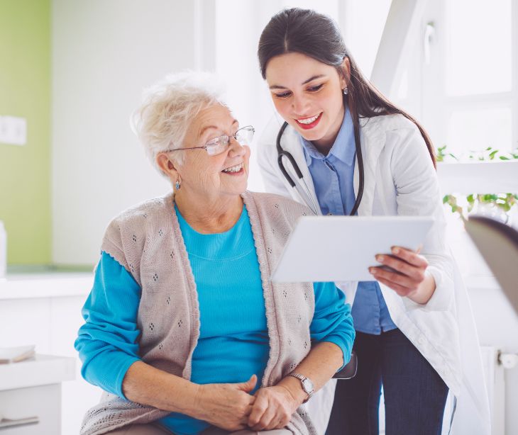 patient looking at tablet with provider