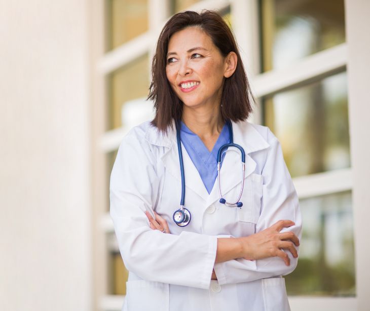 woman in white coat with stethoscope