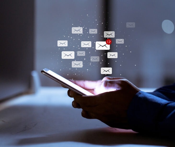 Image of a phone with emails coming out of it. 