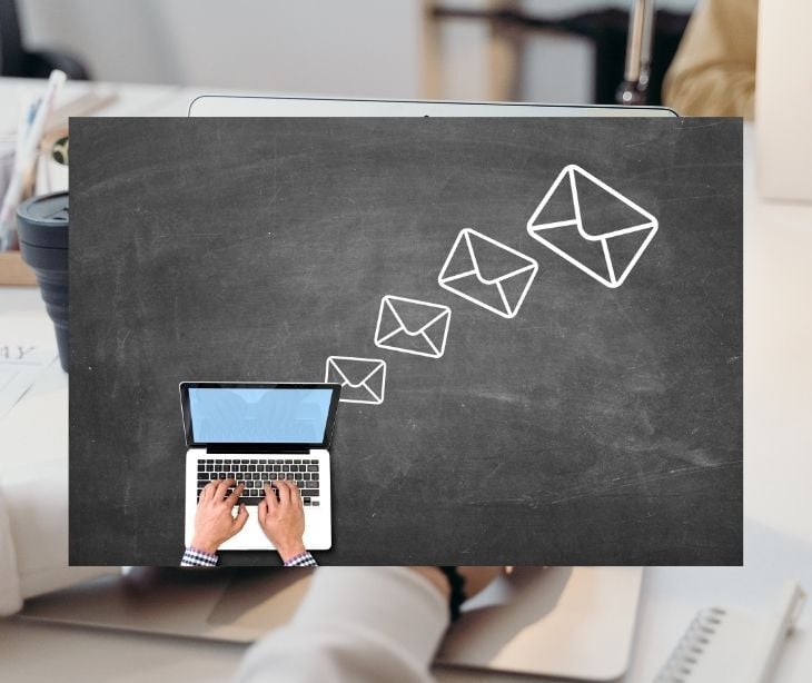 Image of a computer with emails coming out of it. 