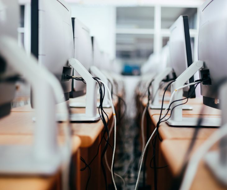 the backside of rows of computers