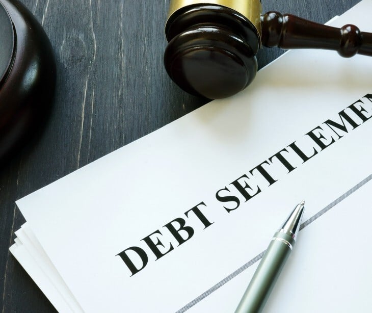 Image of a paper that says "debt settlement" 