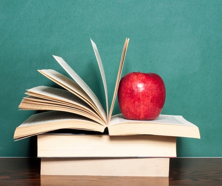 textbook and apple
