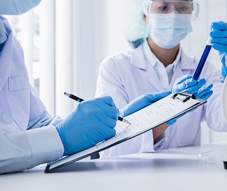 Image of someone taking notes in a clinical setting. 