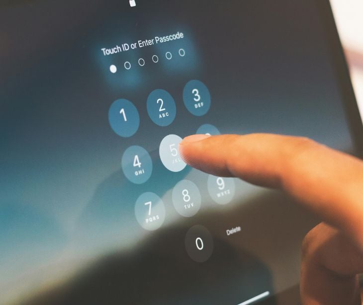 Image of someone typing into a keypad. 