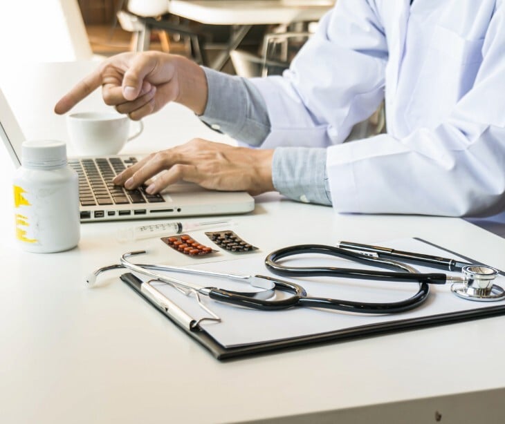 Image of a provider pointing to his laptop. 