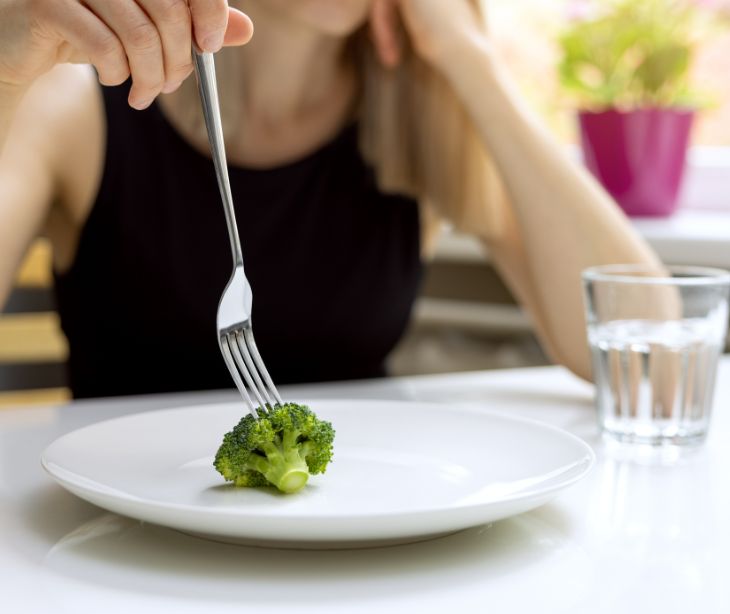 fork and broccoli on plate