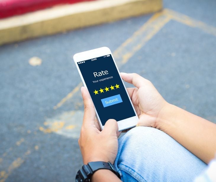 Image of a phone with a five star review open. 