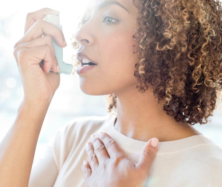 woman using inhaler