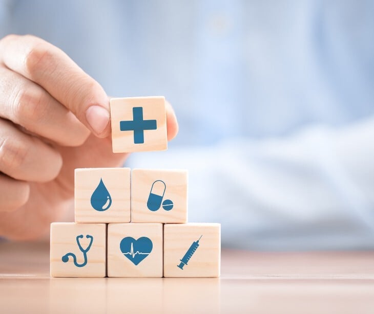 Image of blocks with different simples, including a heart, water, and a health sign. 