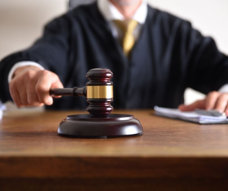 Image of a judge striking a gavel. 