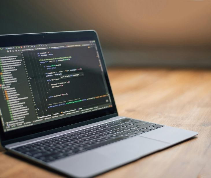 Image of a laptop with code on it. 