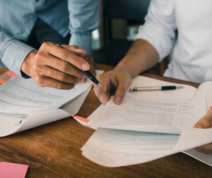 Image of an individual looking at a piece of paper. 