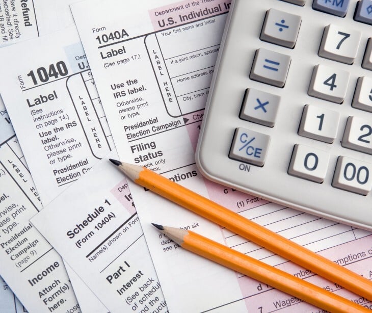 Image of tax documents and a calculator. 