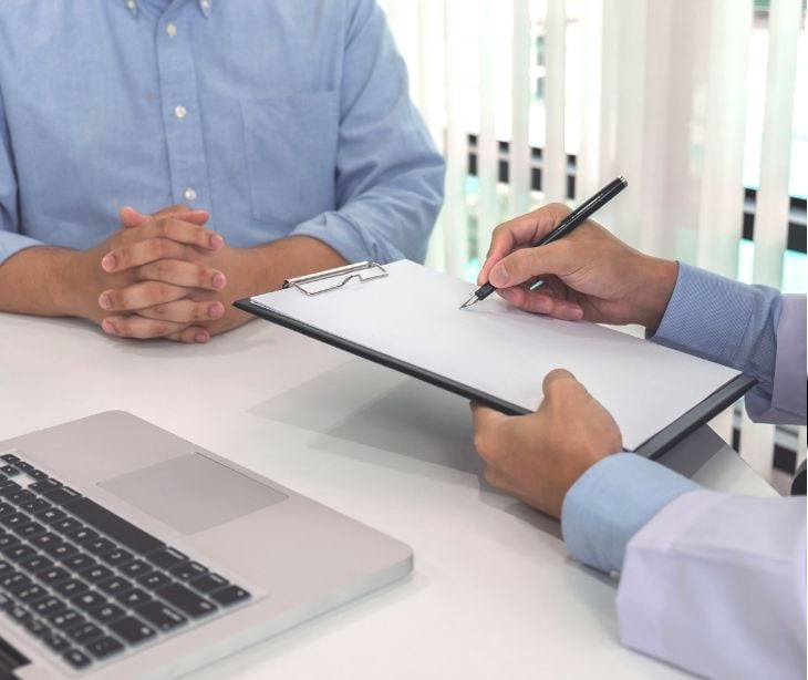 provider and patient signing form on clipboard