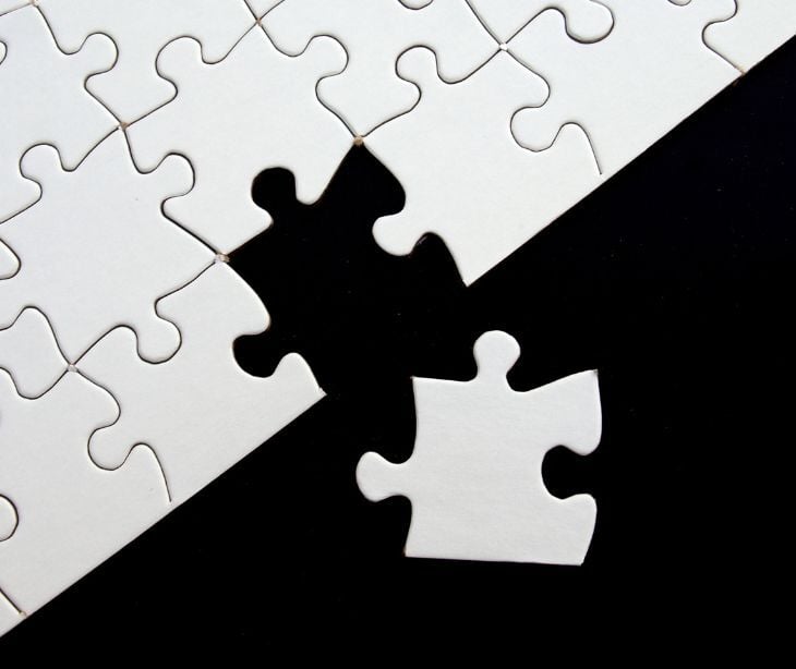 Image of a puzzle with a piece not put in. 