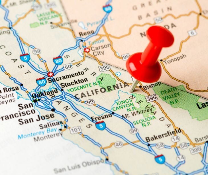 Image of a tack on a map. 