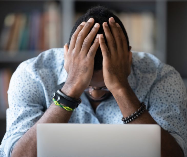 man frustrated at laptop