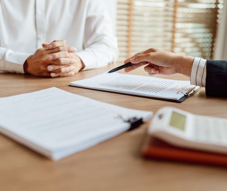 Image of two people talking about a document. 