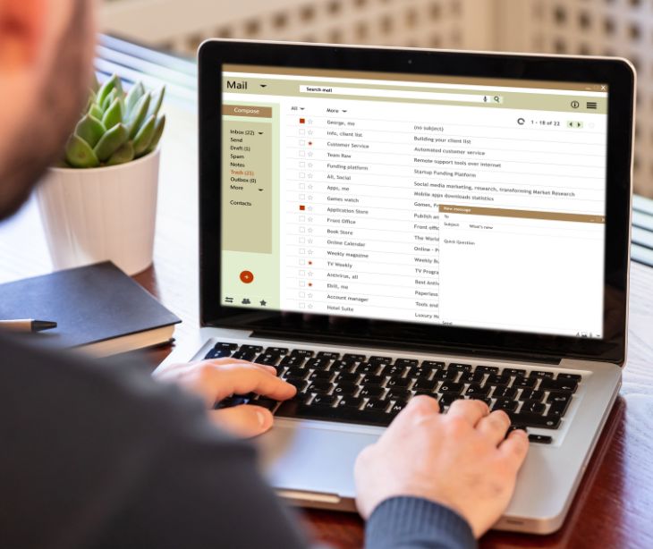 person on laptop sending email 