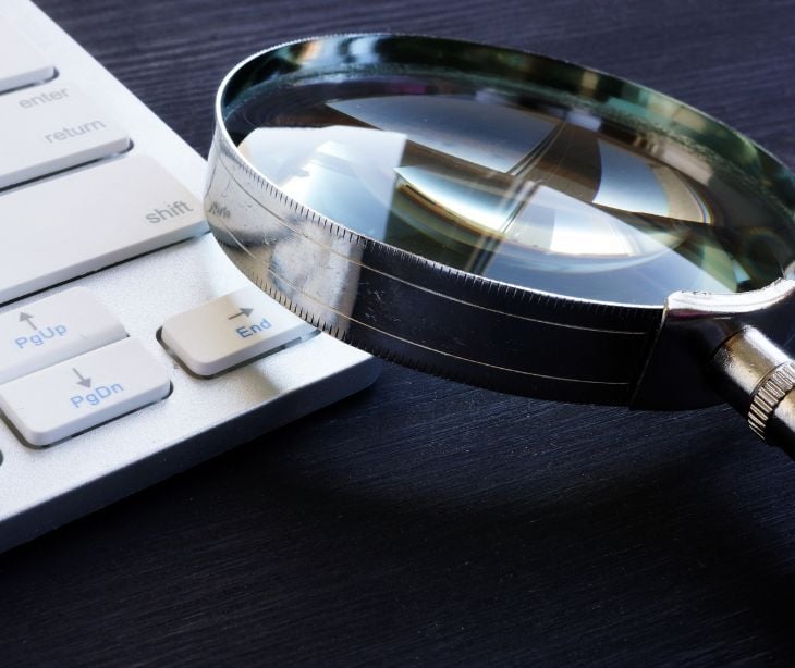 magnifying glass on computer keyboard