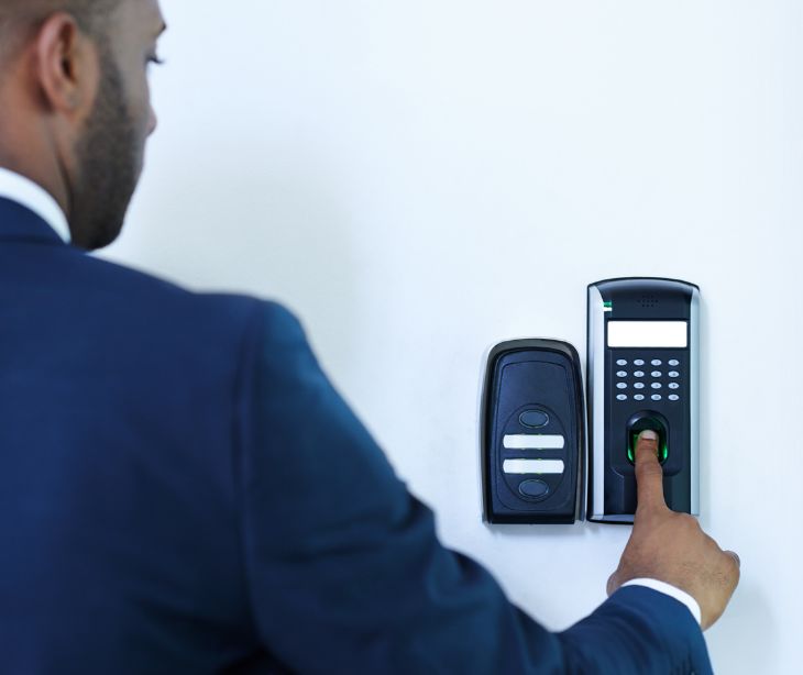 employee scanning fingerprint at entry door