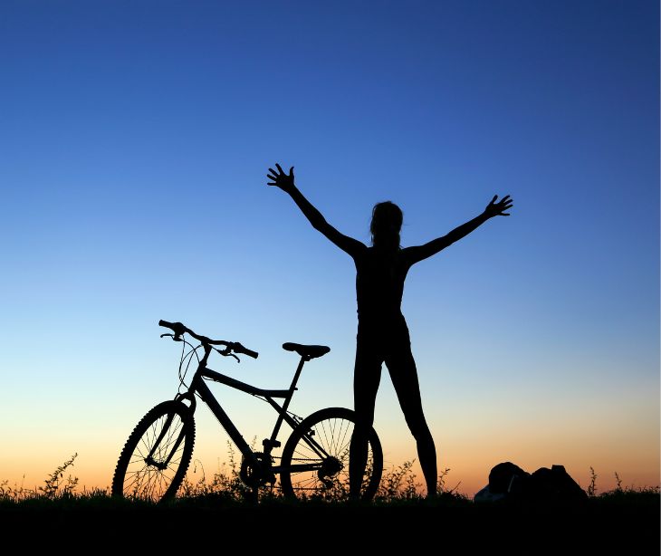 shadow of a person on the horizon with a bike