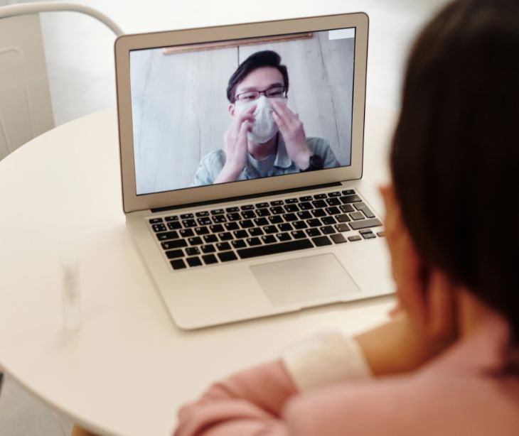 telehealth appointment on laptop with mask wearing