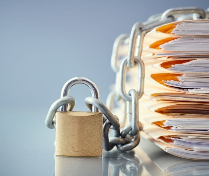 lock and chain next to stack of files