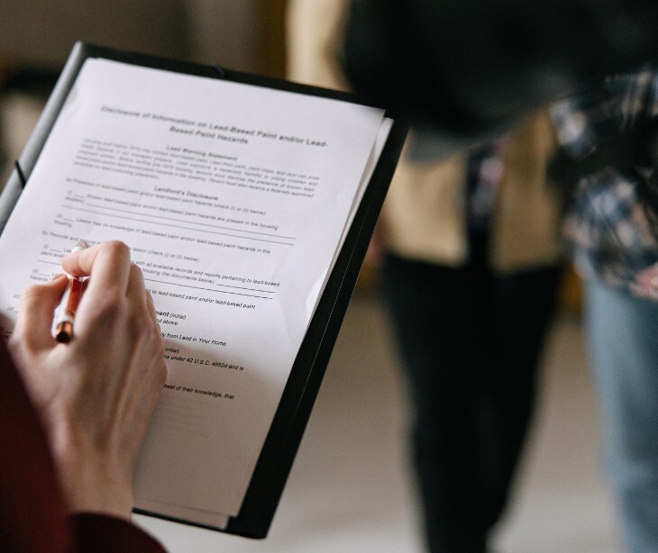 Image of someone signing a document related to estate planning. 