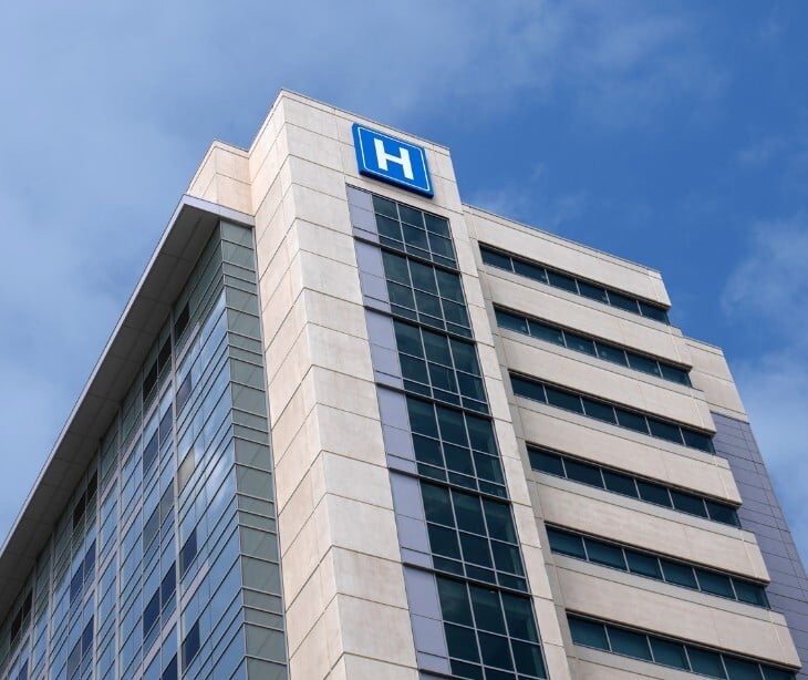 Image of a building with an "H" on it to denote a hospital. 