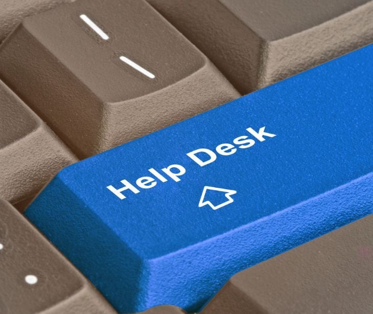 Image of a keyboard with a blue button that says "help desk." 