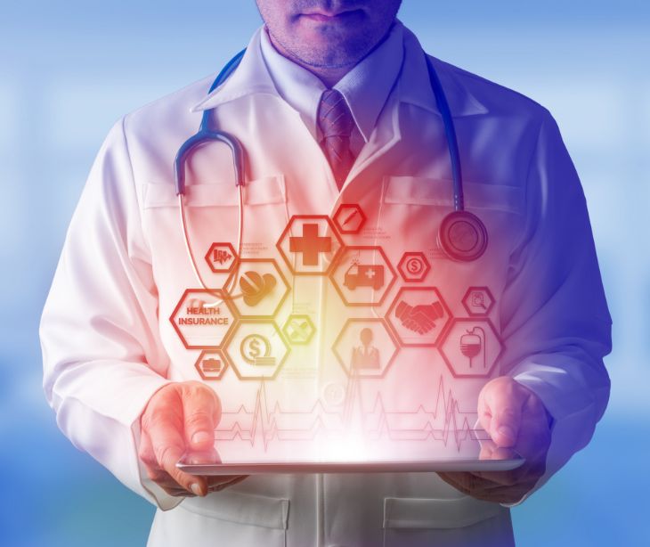 doctor holding tablet with medical symbols