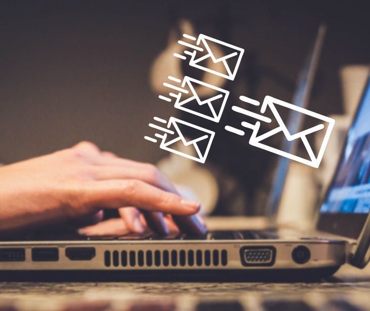 Image of an email coming out of a computer. 