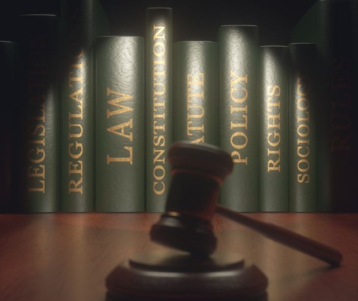 Image of a gavel by some books. 