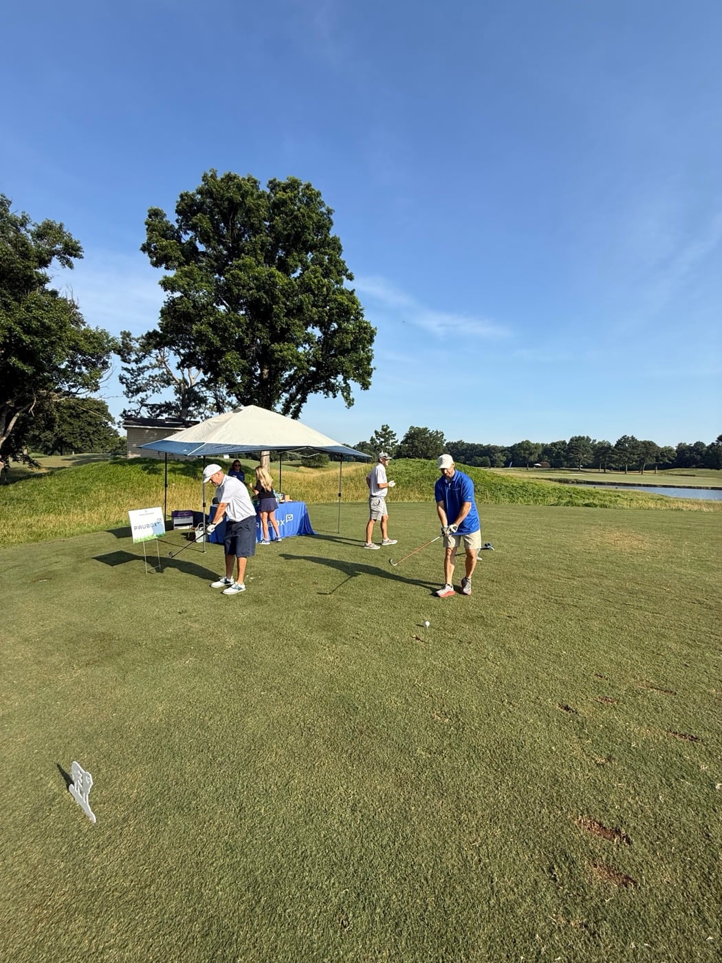 Golfers teeing off at the Paubox hole.